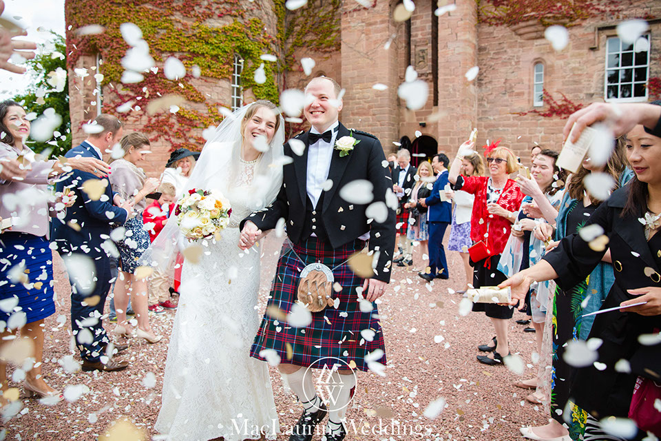 bride and groom at dlahousie castle dride and groom with confetti at dalhousie castle scotland