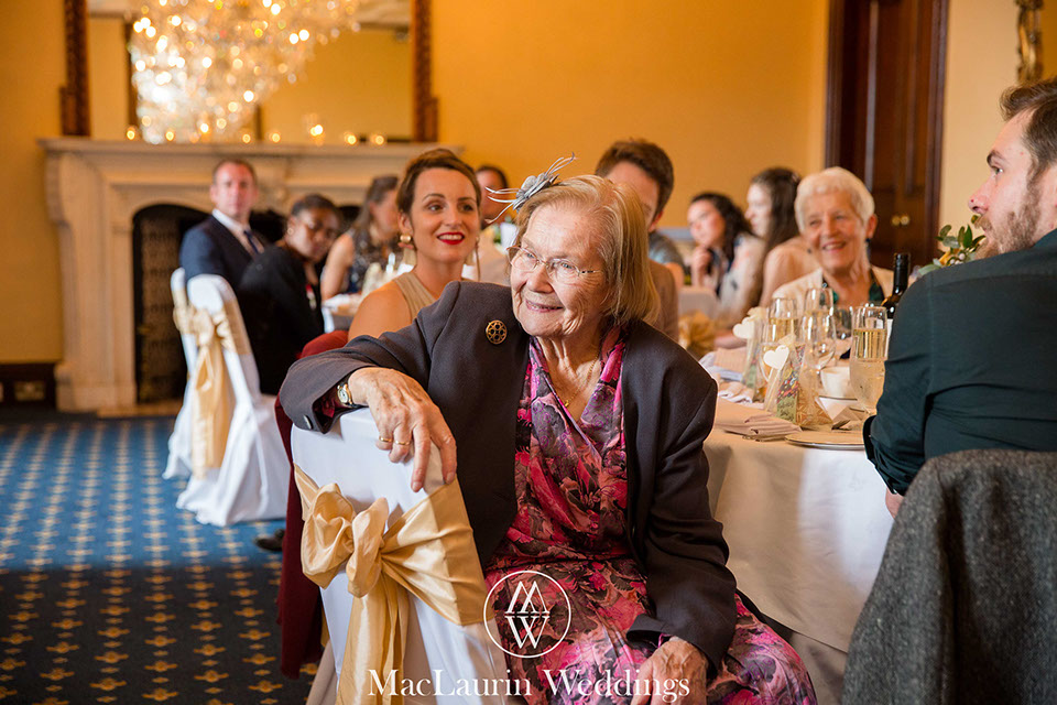 guests at dalhousie castle scotland guests listening to the speeches at a wedding  reception in dalhousie castle scotland