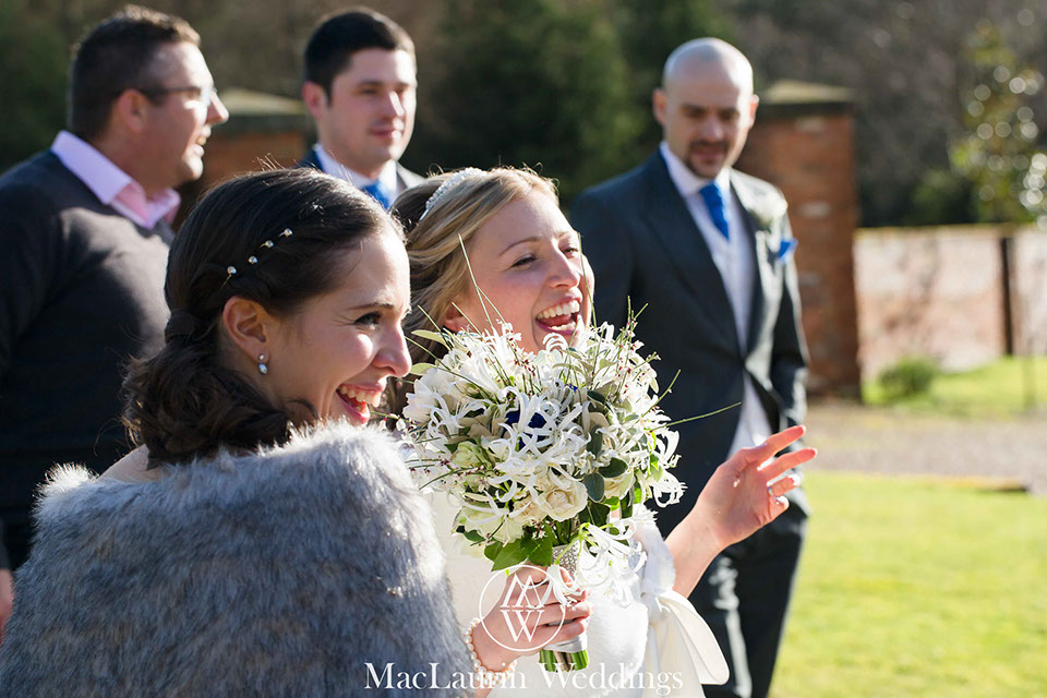 A bride laughing with her guests A bride laughing with her guests