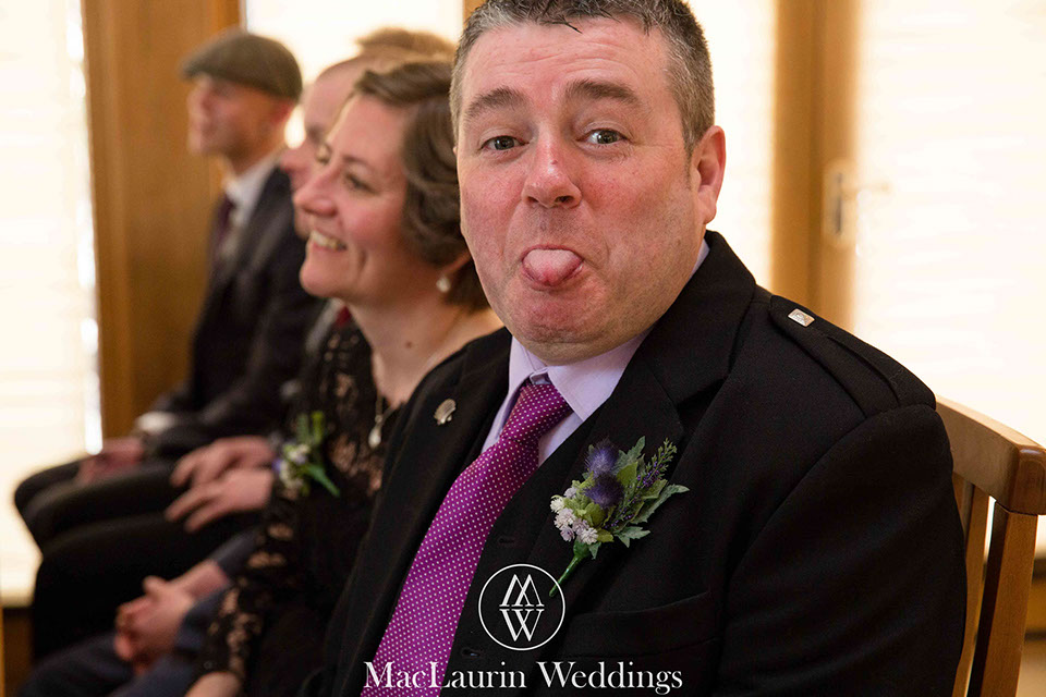 a funny wedding guest a funny wedding guest sticks out his tongue wile getting photographed