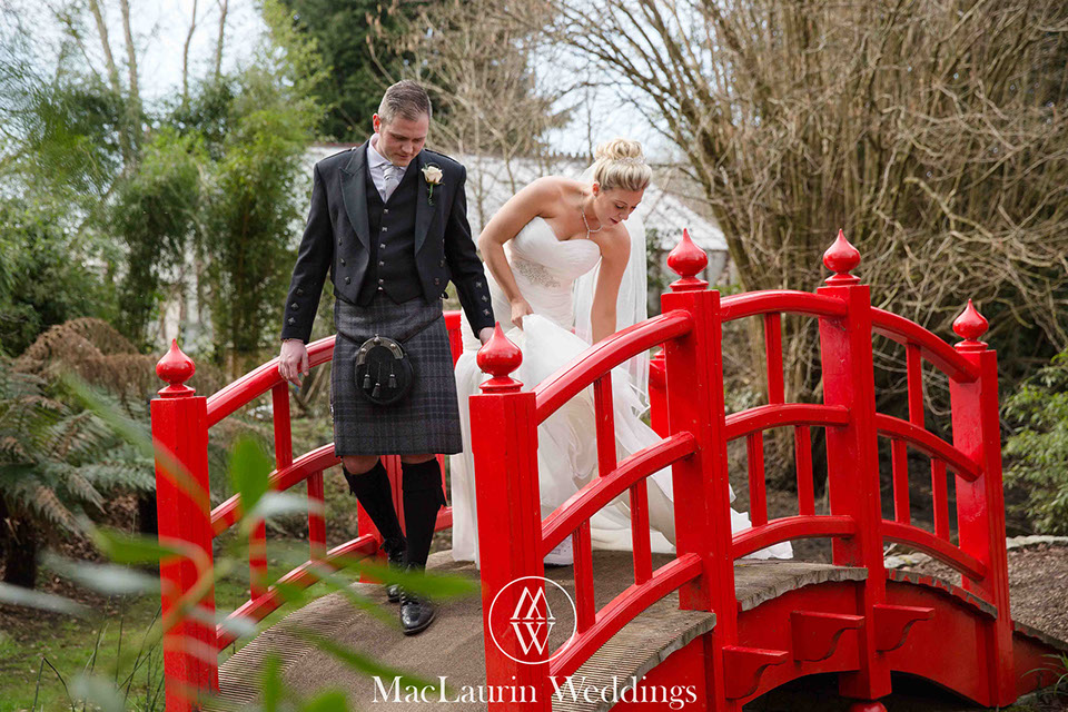 bride and groom walking a bride and groom walking over a bridge